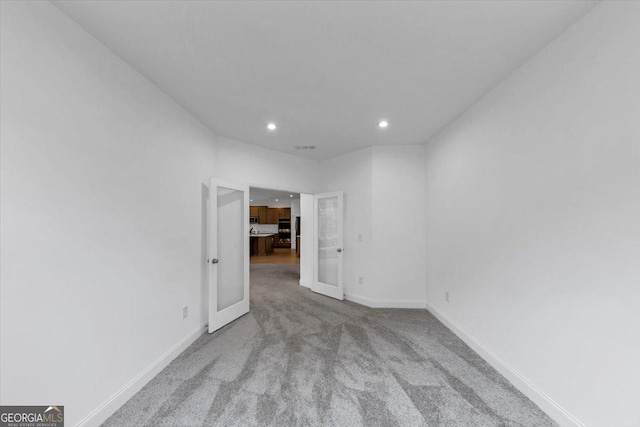 612 Michigan Cir, Hoschton, GA 30548 - spare room featuring recessed lighting, carpet, and french doors