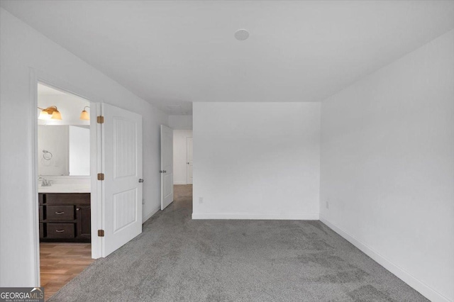 612 Michigan Cir, Hoschton, GA 30548 - unfurnished bedroom featuring carpet floors and ensuite bath