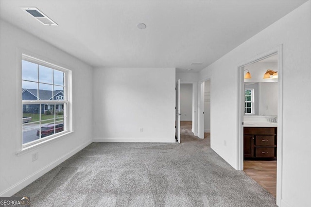 612 Michigan Cir, Hoschton, GA 30548 - unfurnished bedroom with carpet floors and connected bathroom