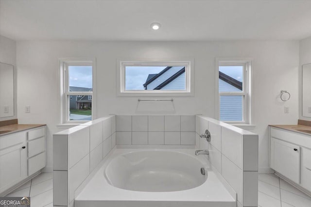 612 Michigan Cir, Hoschton, GA 30548 - full bathroom with two vanities, tile patterned floors, a bath, and recessed lighting