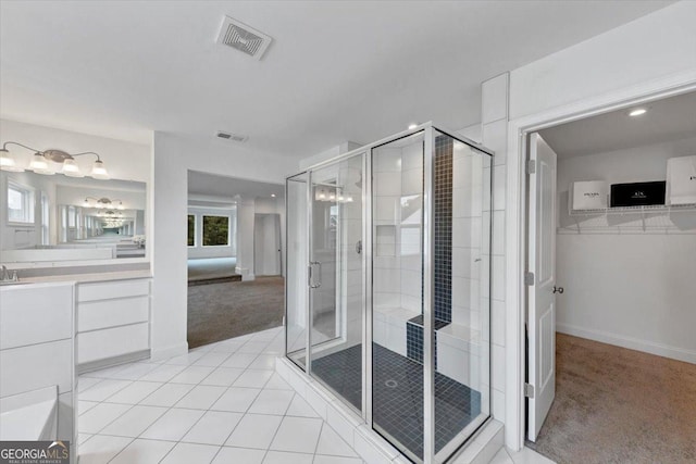 612 Michigan Cir, Hoschton, GA 30548 - full bath with vanity, a shower stall, tile patterned floors, a spacious closet, and recessed lighting
