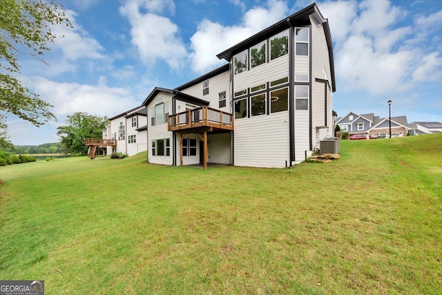 612 Michigan Cir, Hoschton, GA 30548 - rear view of house featuring a deck and a lawn