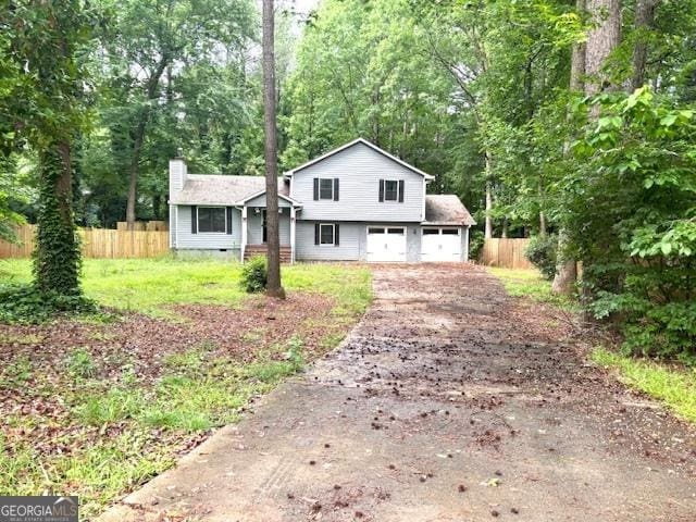 7813 Sugarland Dr, Jonesboro, GA 30236 - split level home with asphalt driveway and a chimney