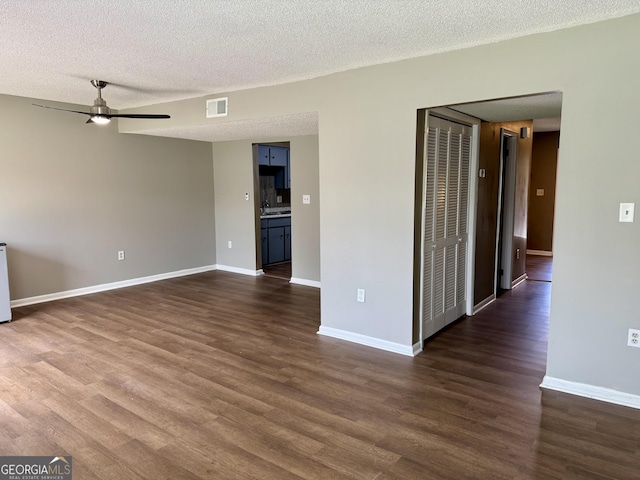 912 Pineland Ave Apt 50, Hinesville, GA 31313 - spare room with ceiling fan, dark wood-type flooring, and a textured ceiling