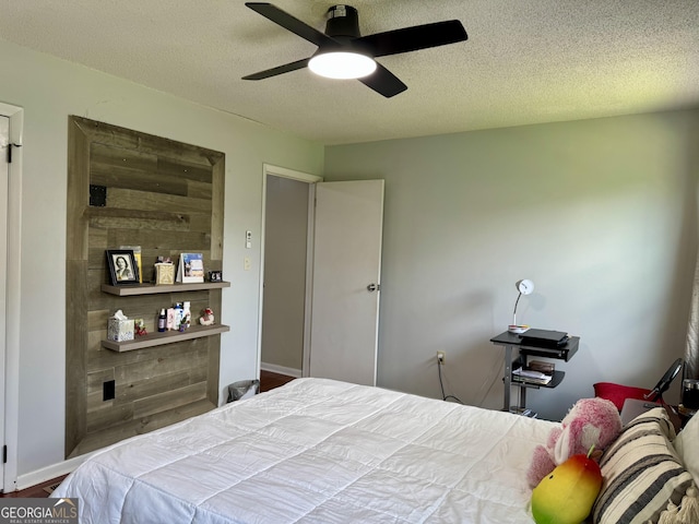 912 Pineland Ave Apt 50, Hinesville, GA 31313 - bedroom with ceiling fan, a textured ceiling, and wood finished floors
