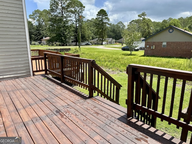 912 Pineland Ave Apt 50, Hinesville, GA 31313 - deck featuring a lawn and view of wooded area