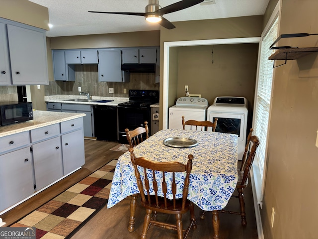 912 Pineland Ave Apt 50, Hinesville, GA 31313 - kitchen with black appliances, under cabinet range hood, washing machine and dryer, light countertops, and ceiling fan