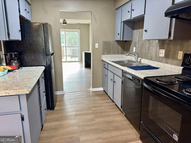 912 Pineland Ave Apt 50, Hinesville, GA 31313 - kitchen featuring black electric range oven, extractor fan, dishwashing machine, light wood finished floors, and light countertops