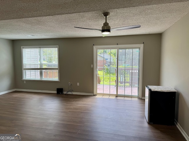 912 Pineland Ave Apt 50, Hinesville, GA 31313 - unfurnished room featuring dark wood-type flooring, a ceiling fan, and a textured ceiling