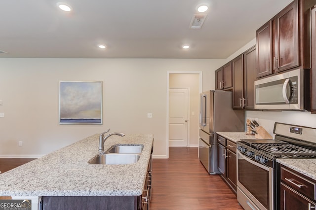 6841 Lancaster Xing, Flowery Branch, GA 30542 - kitchen with appliances with stainless steel finishes, dark brown cabinets, a kitchen island with sink, dark wood finished floors, and recessed lighting