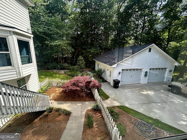 3970 Governors Cir, Loganville, GA 30052 - view of side of property with a garage, view of scattered trees, and driveway