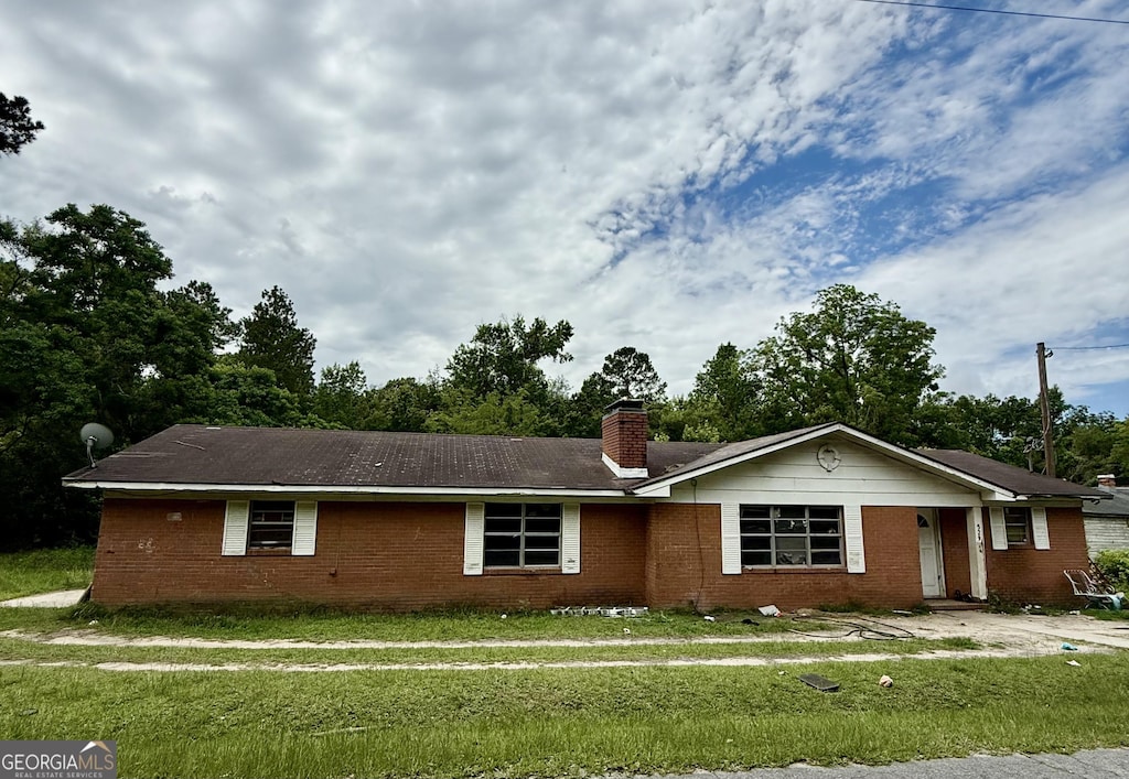 529 College Hts, Portal, GA 30450 - ranch-style house with brick siding, a chimney, and a front lawn