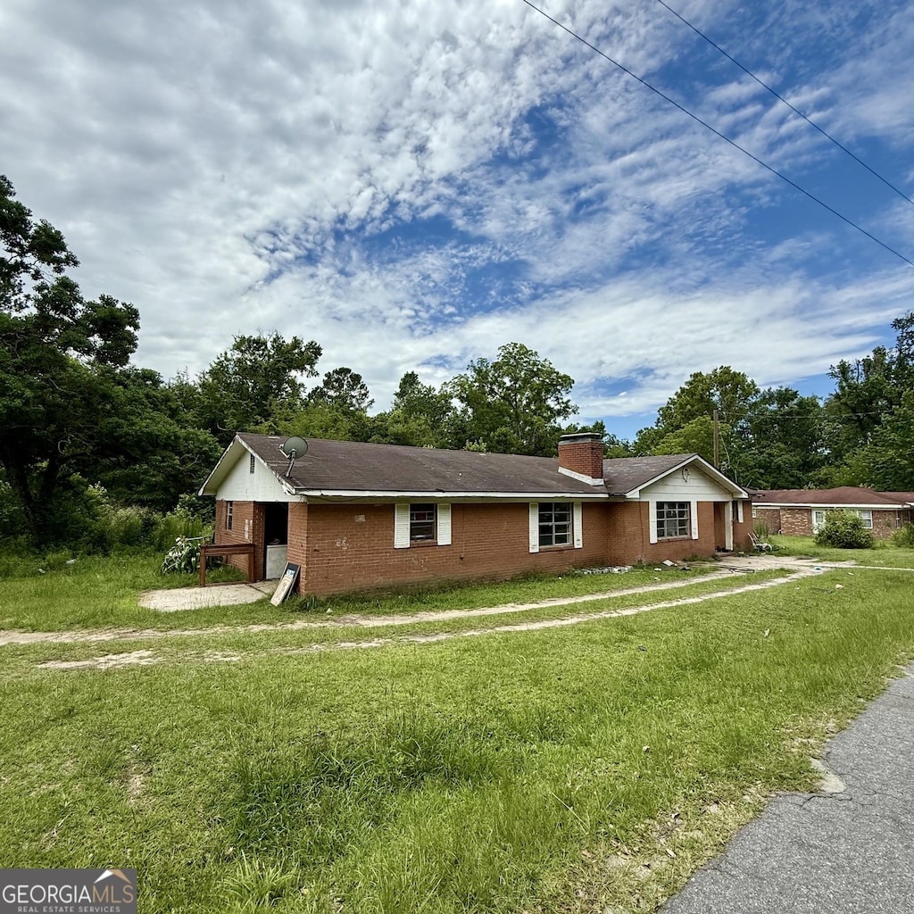529 College Hts, Portal, GA 30450 - ranch-style home with a chimney, a front lawn, and brick siding