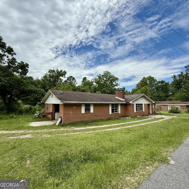 529 College Hts, Portal, GA 30450 - ranch-style home with a chimney, a front lawn, and brick siding