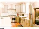 1 Egrets Landing Ct, Savannah, GA 31419 - kitchen featuring decorative backsplash, stove, and light countertops
