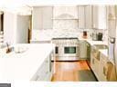 1 Egrets Landing Ct, Savannah, GA 31419 - kitchen featuring light countertops, range, and backsplash