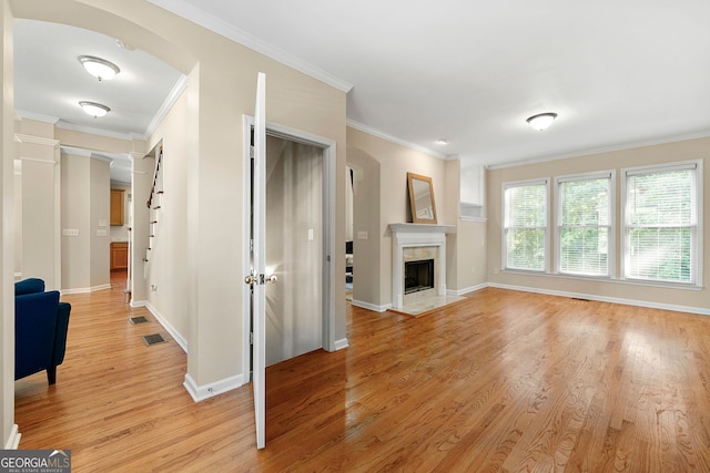 733 Miller Run, Atlanta, GA 30349 - unfurnished living room with light wood finished floors, crown molding, and a fireplace