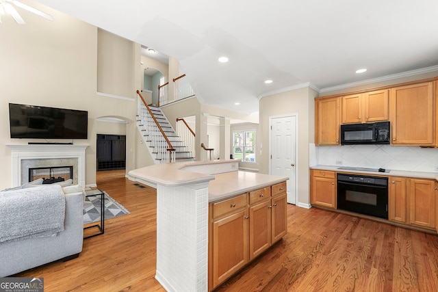 733 Miller Run, Atlanta, GA 30349 - kitchen with black appliances, ornamental molding, open floor plan, a high end fireplace, and arched walkways