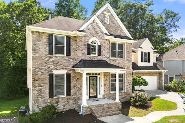 733 Miller Run, Atlanta, GA 30349 - view of front of property with driveway, roof with shingles, an attached garage, and brick siding