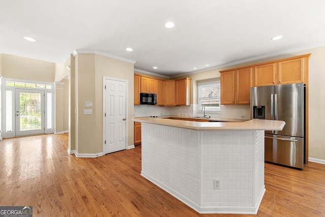 733 Miller Run, Atlanta, GA 30349 - kitchen featuring stainless steel fridge, black microwave, light countertops, backsplash, and a kitchen island