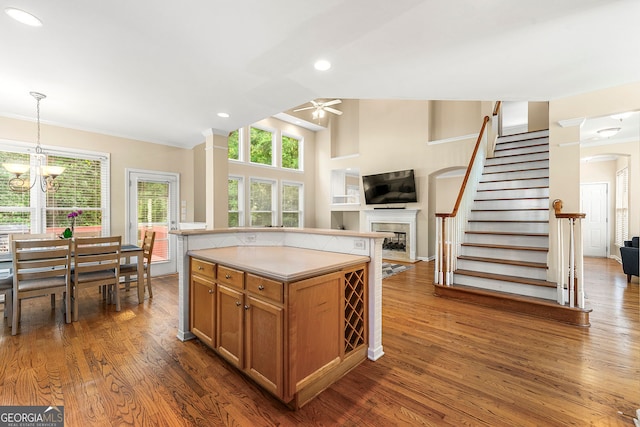 733 Miller Run, Atlanta, GA 30349 - kitchen featuring a ceiling fan, open floor plan, a fireplace, brown cabinets, and recessed lighting