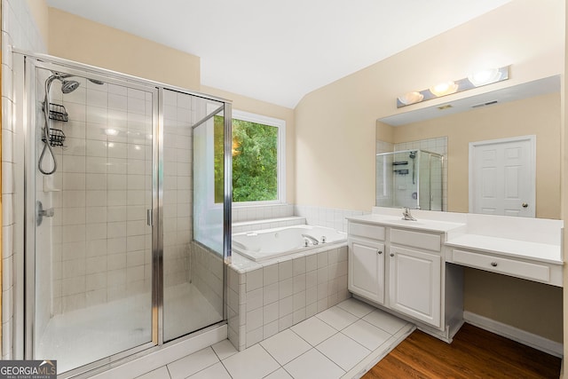 733 Miller Run, Atlanta, GA 30349 - full bath with a stall shower, vanity, a garden tub, wood finished floors, and lofted ceiling
