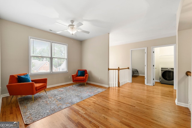 733 Miller Run, Atlanta, GA 30349 - sitting room with washer / clothes dryer, a ceiling fan, and light wood finished floors