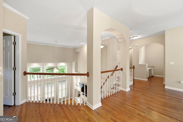 733 Miller Run, Atlanta, GA 30349 - corridor with an upstairs landing, wood finished floors, crown molding, and arched walkways
