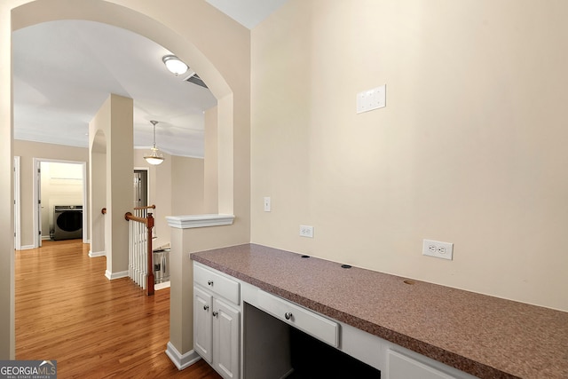 733 Miller Run, Atlanta, GA 30349 - corridor featuring washer / clothes dryer, wood finished floors, and arched walkways