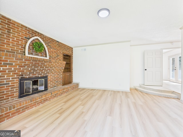 6417 Carey Pl, Macon, GA 31216 - unfurnished living room with wood finished floors, a brick fireplace, and ornamental molding