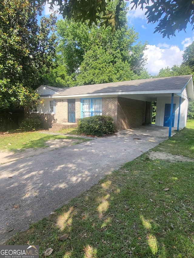4274 W Oak Dr, Macon, GA 31210 - view of front of house featuring concrete driveway, an attached carport, a front lawn, and brick siding