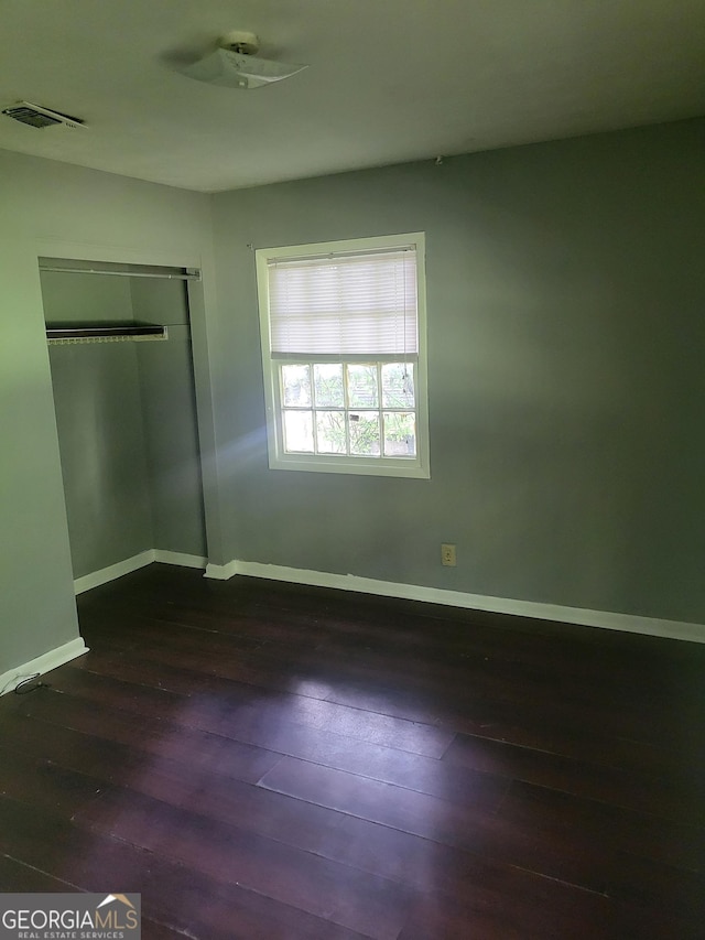 4274 W Oak Dr, Macon, GA 31210 - unfurnished bedroom featuring dark wood-style flooring and a closet