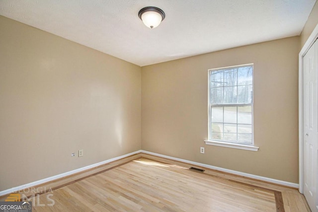 48 Glenhaven Ct, Douglasville, GA 30134 - spare room featuring light wood-type flooring and plenty of natural light