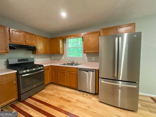 48 Glenhaven Ct, Douglasville, GA 30134 - kitchen featuring stainless steel appliances, under cabinet range hood, light countertops, and light wood-type flooring