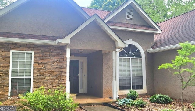 455 Old Ivy Path, Mcdonough, GA 30253 - doorway to property with stone siding, stucco siding, and a shingled roof