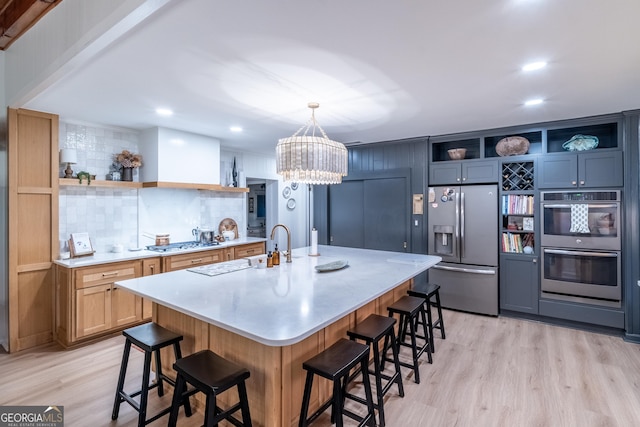 8815 Campbellton St, Douglasville, GA 30134 - kitchen featuring open shelves, appliances with stainless steel finishes, a kitchen breakfast bar, decorative backsplash, and light wood finished floors