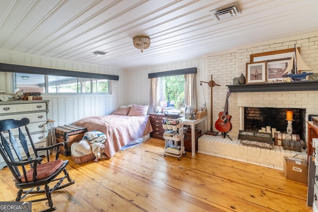 8815 Campbellton St, Douglasville, GA 30134 - bedroom with hardwood / wood-style floors, a fireplace, and brick wall