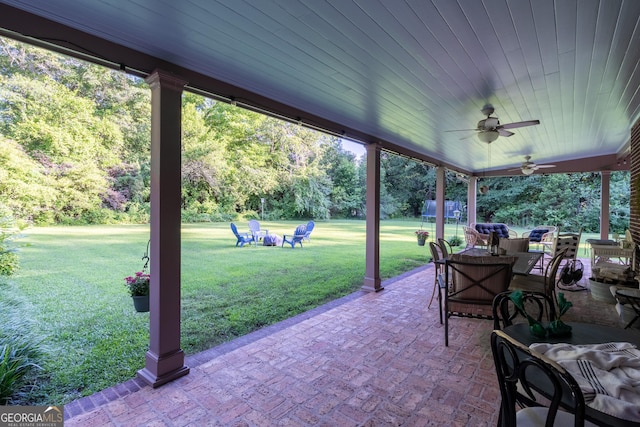 8815 Campbellton St, Douglasville, GA 30134 - view of patio / terrace with a ceiling fan, outdoor dining space, and view of wooded area