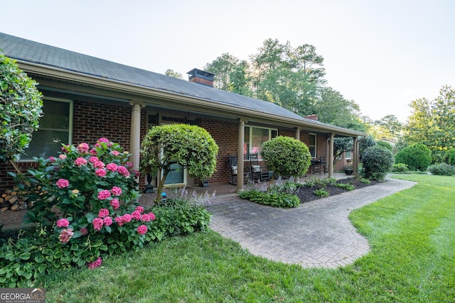 8815 Campbellton St, Douglasville, GA 30134 - view of home's exterior with a yard, brick siding, and a chimney