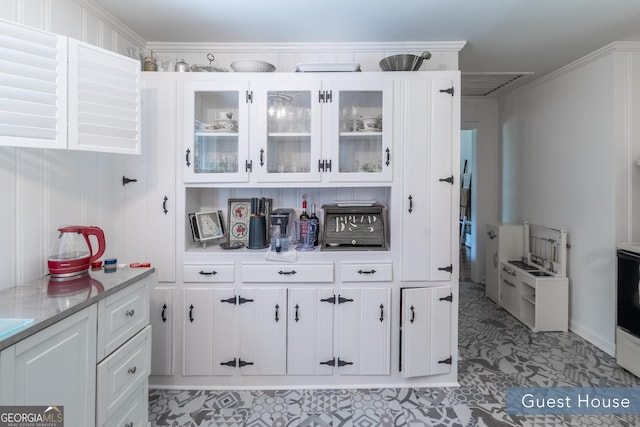 8815 Campbellton St, Douglasville, GA 30134 - kitchen featuring white cabinetry and glass insert cabinets