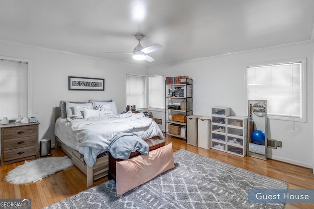8815 Campbellton St, Douglasville, GA 30134 - bedroom featuring ornamental molding, wood finished floors, and ceiling fan