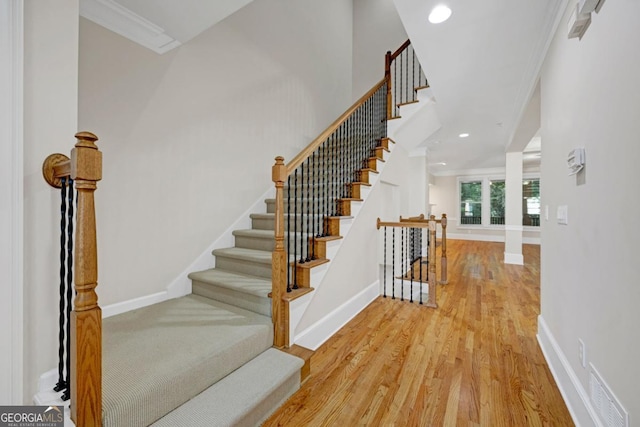 4742 Legacy Cove Ln, Smyrna, GA 30126 - stairway with ornamental molding, wood finished floors, and recessed lighting
