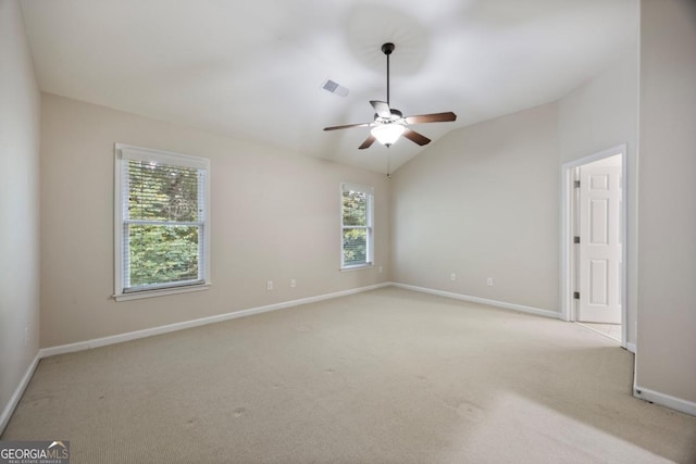 4742 Legacy Cove Ln, Smyrna, GA 30126 - empty room featuring light colored carpet, ceiling fan, and vaulted ceiling