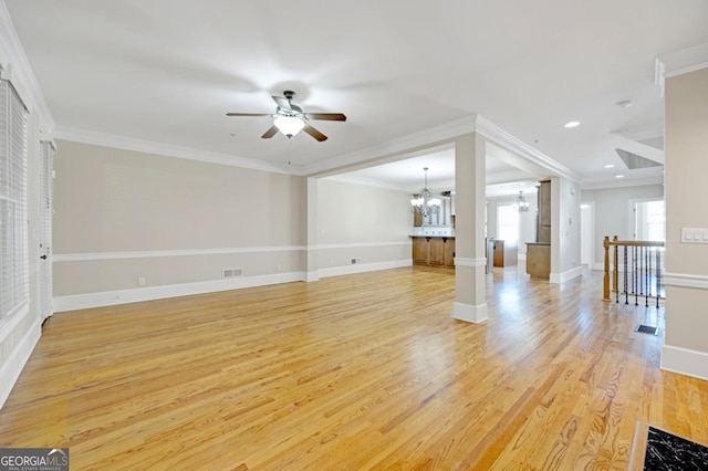 4742 Legacy Cove Ln, Smyrna, GA 30126 - unfurnished living room with a chandelier, ceiling fan, light wood-style floors, ornamental molding, and recessed lighting