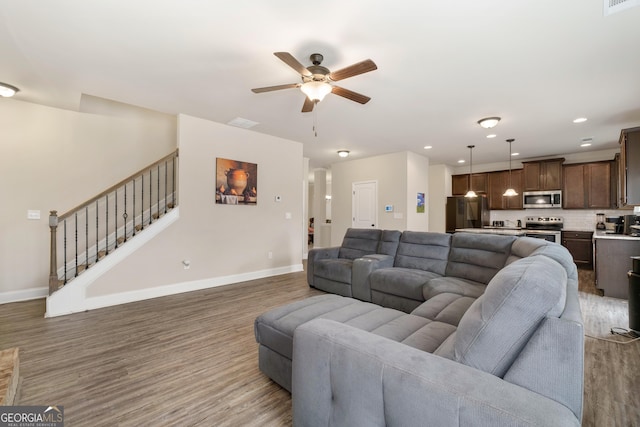2277 Church St, Hampton, GA 30228 - living area with wood finished floors, a ceiling fan, stairway, and recessed lighting