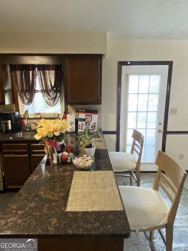 110 Waverly Way, Lagrange, GA 30240 - kitchen featuring plenty of natural light, dark brown cabinetry, and dark stone counters