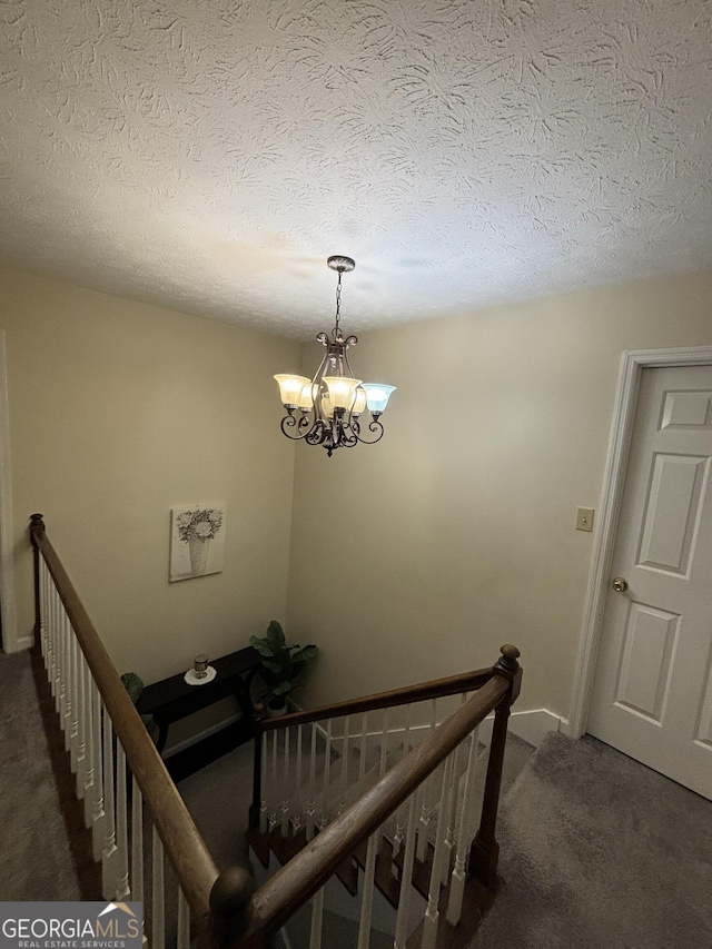 110 Waverly Way, Lagrange, GA 30240 - staircase featuring carpet floors, a chandelier, and a textured ceiling