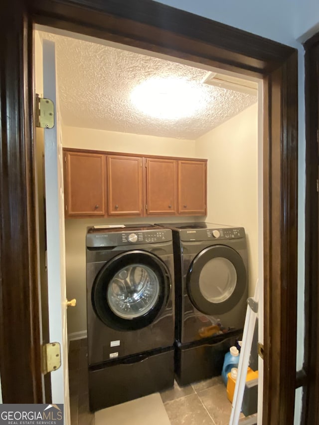 110 Waverly Way, Lagrange, GA 30240 - washroom with washing machine and dryer, a textured ceiling, light tile patterned flooring, and cabinet space