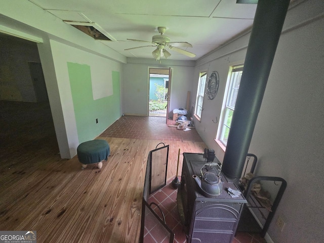 1048 Seals Rd, Dallas, GA 30157 - living room featuring wood-type flooring, a ceiling fan, and a wood stove