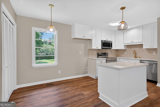 116 Preston Pl, Lagrange, GA 30241 - kitchen with stainless steel appliances, dark wood-type flooring, decorative backsplash, and white cabinets